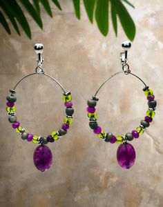 These stunning clip-on earrings feature silver hoops adorned with purple and green multi-colored beads. The 2 3/4" size makes them the perfect statement piece for any outfit. No piercing necessary, making them easy and comfortable to wear. Add a touch of color and style to your look with these unique earrings! Bead Hoop Earrings, Turquoise Hoops, Purple And Green, Beaded Hoop Earrings, Beaded Hoops, Earring Sale, Jewelry Earrings Hoops, Silver Hoops, Purple Green