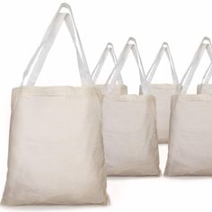 four bags with handles are lined up against each other, one is white and the other is beige