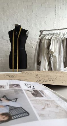 a dressmaker's mannequin is shown next to some clothes