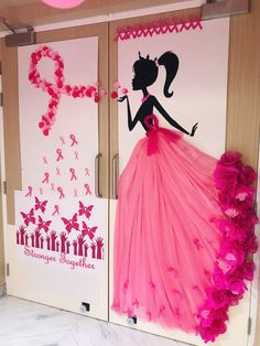 two doors decorated with pink and black paper flowers, one in the shape of a woman's dress