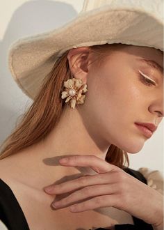 Add a touch of elegance and playfulness to any outfit with our Gold Floral Pearl Rhinestone Statement Earrings. The inlaid rhinestones and imitation pearls make these earrings a unique and beautiful addition to your jewelry collection. Perfect for a night out or to elevate your everyday look. 4 1/2" (4.4cm) drop 1 1/4" (3.7cm) width Post back Alloy, imitation pearl, rhinestone Women's earrings Item #460702 Party Pearl Clip-on Earrings, Pearl Embellished Earrings For Party, Elegant Clip-on Flower Earrings For Party, Clip-on Flower Earrings For Party, Clip-on Metal Pearl Earrings, Party Clip-on Flower Earrings, Party Pearl Drop Flower Earrings, Gold Statement Earrings, Gift Box Packaging