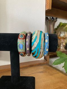 "4, Bangle Stack, Turquoise Bangles, Clamper Bracelets, Blue Bracelets, Small Wrist, iris apfel A group of 4 clampers, hinged bangles, bracelets from the 90s in complimentary colors! Diameter is 2\" - for a smaller wrist like mine! Group measures 3\". Wear one, two, or all at a time :) Perfect condition. Staff: Mid left inv - BLU3" Unique Handmade Blue Bangle, Unique Blue Bangle Cuff Bracelet, Blue Bohemian Bangle Jewelry, Unique Blue Beaded Bangle Bracelets, Blue Bracelet With Unique Variations, Unique Blue Bangle Jewelry, Unique Blue Bangle, Vintage Blue Bangle Bracelets, Blue Bracelets With Unique Variations