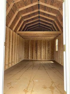 an empty room with wooden walls and ceiling