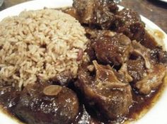 a white plate topped with meat and rice