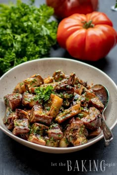 a white bowl filled with cooked vegetables next to tomatoes and parsley on a table