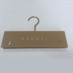 a hanger with the word hanger written on it and two hooks attached to it