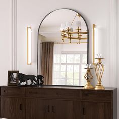 a large mirror sitting on top of a wooden dresser