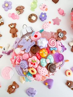 a bunch of buttons are laying on the table next to some teddy bear magnets