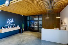 the inside of a store with blue walls and wooden ceilinging, along with white counter tops