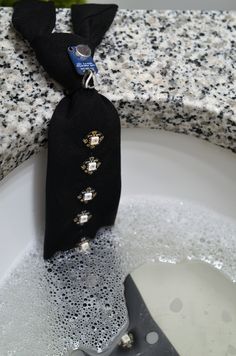 a black tie sitting on top of a white sink