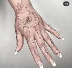 a woman's hand with some tattoos on it