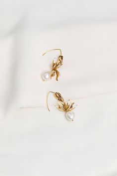 Natural Pearl 24K Gold Plated Stud Earrings * Floral Bridal Earrings * Flower Drop Bridal Earrings * Dangle Natural Pearl Earrings | GAILA Earrings   --Gaila We combined glowing freshwater pearls with golden flowers detailing in a drop silhouette to create the Gaila earrings. Delicate and romantic, these ethereal earrings are the perfect pair for your most special moments and the everyday alike.   ✎     Gold plated with a thick layer of 24 carat gold brass, gold vermeil     Attached to 925 sterl Gold Flower Hoop Earrings For Wedding, Gold Floral Hoop Earrings For Wedding, Gold Flower Bridal Earrings, White Gold Plated Danglers For Gift, Gold Flower Shaped Pearl Drop Earrings, Gold Drop Pearl Earrings For Celebration, Gold Flower-shaped Pearl Earrings As Gift, Gold Flower Pearl Earrings For Gift, Gold Plated Dangle Flower Earrings For Wedding