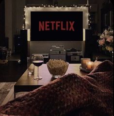 a living room filled with furniture and a flat screen tv sitting on top of a wooden table