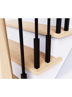 three wooden shelves with black poles on them