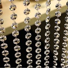 some crystal beads hanging from the side of a window