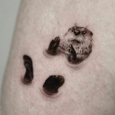 a close up of a person's leg with an animal paw print on it