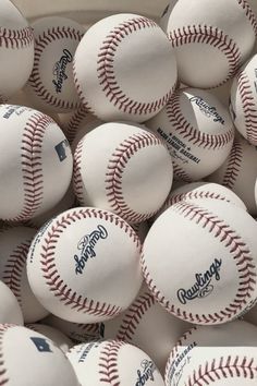 a bucket full of baseballs sitting on top of each other