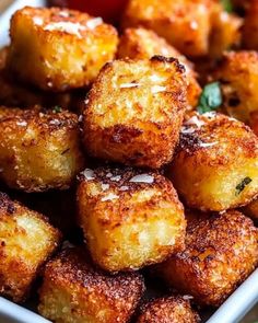 some fried food in a white bowl on a table