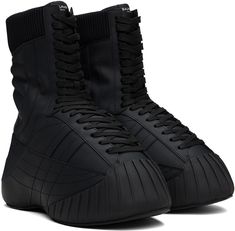 Mid-calf rubberized calfskin boots in black. · Topstitching throughout · Rubber cap toe · Lace-up closure · Logo patch at tongue · Rib-knit collar · Padded jersey lining · Covered platform midsole · Treaded rubber sole · Platform: H2 Supplier color: Noir Black Stitched Sole Lace-up Boots For Fall, Black High-top Lace-up Boots In Calf Leather, Sporty Black Boots With Rubber Toe Cap, Winter Lace-up Boots With Rubber Sole In Calf Leather, Black Leather Insulated Lace-up Boots, Black Insulated Leather Lace-up Boots, Winter Streetwear Boots With Rubber Toe Cap, Insulated Leather Boots For Streetwear, Black High-top Lace-up Boots With Rubber Heel Cap