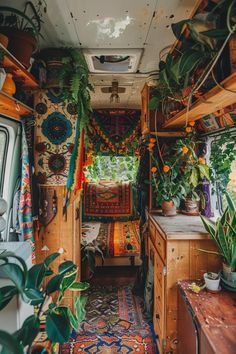 the interior of an rv decorated with plants and rugs