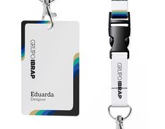 a keychain with a name tag attached to it next to an id card