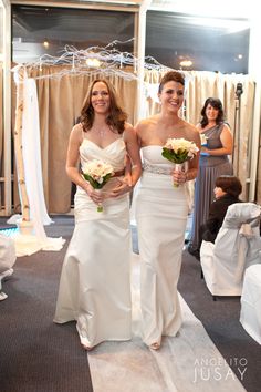 two brides walking down the aisle at their wedding