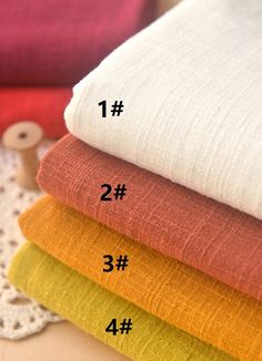 four different colored linens stacked on top of each other with numbers in front of them