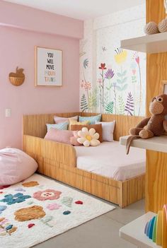 a child's bedroom with pink walls and wooden shelves, stuffed animals on the bed