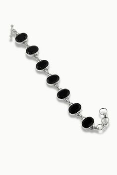 Be the vision of wild, sunkissed charm with our Splendor Black Onyx Bracelet. With an endless loop of symmetrical oval Black Onyx Gemstones adorning your wrist, we’re confident you’ll be the center of all attention. Be unapologetically your best and never stop dreaming. Authentic Sivalya Black Onyx Hallmarked Metal: 925 Sterling Silver Adjustable Length: 7.5" - 8.5" Links Gemstone Size: 15mm x 10mm Cut: Oval Cushion Cut Cabochons Black Onyx: Endurance, Perseverance, Grounding Black Onyx Bracelet, Stop Dreaming, Never Stop Dreaming, Onyx Bracelet, The Vision, Cushion Cut, Black Onyx, Onyx, Silver Bracelet