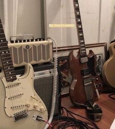 guitars and amps are lined up on the floor