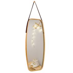 a surfboard shaped mirror with shoes hanging from it's sides and lights on the bottom