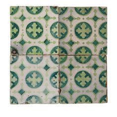 green and white tiles with designs on them