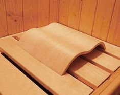 a wooden bench that has been made out of plywood and is sitting in a wood paneled room