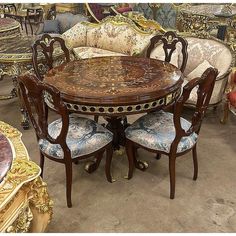 a dining table and chairs are in a room with many different types of fabrics on the walls