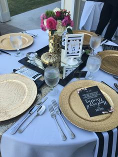 the table is set with plates and silverware