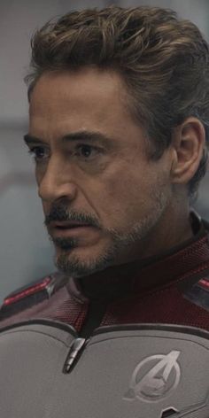 the avengers movie character is looking into the distance with an intense look on his face