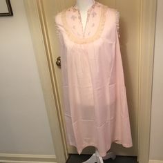 Rare - Never Worn! Gown Is Sleeveless Pale Pink Embroidered And Lace Trim. V-Neck, One Bottom, Over The Head. Fabric Semi-Sheer Is 44% Polyester, 32% Nylon, 24% Cotton. Matching Long Sleeve Robe Has The Same Trim At Neckline And Cuffs, Fabric Covered Buttons. Fabric Is 40% Polyester, 35% Nylon, 25% Cotton. First Four Pictures Show Gown Only, Second Four Pictures Show Robe Over Gown. With The Robe Flat On A Table, It Measures 21 Inches Across From Arm Pit To Arm Pit. The Length Of The Robe Is 41 Sleeveless Cotton Chemise For Daywear, Cotton Sleeveless Daywear Chemise, Feminine Sleeveless Night Chemise, Pink Sleeveless Nightgown For Bedtime, Feminine Pink Sleeveless Chemise, Sleeveless Pink Cotton Nightgown, Pink Sleeveless Cotton Nightgown, Sleeveless Nightgown For Spring Loungewear, Sleeveless Pink Nightgown For Sleep