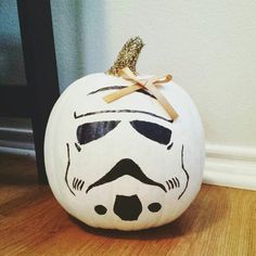 a white pumpkin with a star wars face painted on it