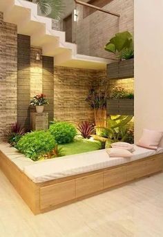 the interior of a house with plants and bookshelves on the wall next to the stairs