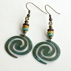 "Boho Spiral Earrings - Lightweight Verdigris Patina Brass Spirals dangle from Turquoise, Tortoise Colored, and Dark Red Czech Glass Beads The spirals are 1\" in diameter (approximately size of US quarter). Antiqued Brass Earwires For other Boho Earrings: https://www.etsy.com/shop/mcstoneworks?search_query=boho+earrings" Patina Jewelry, Silver Dragonfly Necklace, Patina Earrings, Tortoise Color, Dragonfly Jewelry, Earrings Turquoise, Spiral Earrings, Botanical Jewelry, Lightweight Earrings