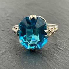 Vintage Blue Cubic Zirconia Sterling Silver Statement Ring, UK Size K1/2, US Size 5 1/4, EU Size 50 1/4, Stamped Silver, Front Max Width 12.6mm, Weight 2.42 Grams, Lovely Condition Vintage Blue Topaz Ring With Diamond Cut, Blue Aquamarine Diamond Cut Rings, Blue Faceted Sapphire Ring For Wedding, Handmade Blue Topaz Ring For Formal Occasions, Vintage Blue Ring With Diamond Cut, Vintage Blue Diamond Cut Jewelry, Vintage Blue Jewelry With Diamond Cut, Blue Vintage Jewelry With Diamond Cut, Vintage Blue Jewelry With Prong Setting