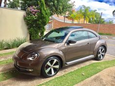 a brown car parked in front of a house