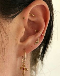 a close up of a person's ear with two different types of piercings