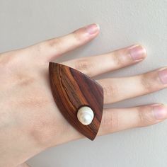 This contemporary wooden ring is hand fabricated from sterling silver, cocobolo wood, pearl.This modern pearl ring will be a great 5th anniversary gift for her or a lovely gift for nature lovers.  This modern wooden ring have also matching earrings. -The wooden ring weighs approximately 0.31 ounce (8.8g) - You'll get the silver wood jewelry in a little box ready to give away and also you can add a gift message during purchase - No CNC or similar tools have been used, each ring is handmade. Pleas Ring Pearl Modern, Ring Pearl, Silver Wood, Wooden Accessories, Wood Accessories, 5th Anniversary, Wooden Ring, Anniversary Jewelry, Wood Creations