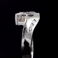 a white gold ring with two diamonds on the top and bottom, set in 18k white gold