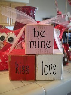 wooden blocks that say be mine, kiss love and owl on top of each other