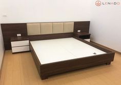 a bed sitting in the middle of a room next to a white dresser and drawers