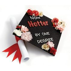 a graduation cap decorated with flowers and the words now hofter by one degree