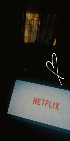 the netflix logo is displayed on a laptop screen