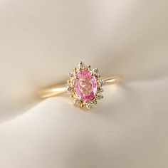 This is made to order ring. Beautiful unheated pink sapphire from Madagascar, weight ranges from 0.60 to 0.7ct, 7x5mm, eye clean 0.08ctw., G color SI clarity accent diamonds Band width: approx. 1.9mm High profile setting, easy stacking with a straight band Made of recycled solid 14k gold Our Dedication All our jewelry is designed and created by Kat with great attention to details and the entire production from casting, stone setting to finishing takes place in New York, USA. All gemstones used i Pink Oval Diamond Ring With Center Stone, Pink Oval Cluster Ring With Center Stone, Pink Oval Cluster Ring Fine Jewelry, Pink Ruby Promise Ring With Halo Setting, Pink Diamond Cluster Ring With Halo Setting, Pink Oval Cluster Promise Ring, Pink Oval Halo Ring For Formal Occasions, Formal Oval Pink Halo Ring, Formal Pink Oval Halo Ring